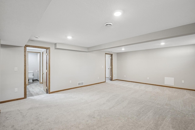 finished basement with recessed lighting, visible vents, baseboards, and carpet