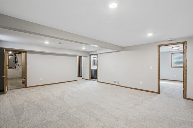 basement with visible vents, baseboards, electric panel, carpet flooring, and recessed lighting