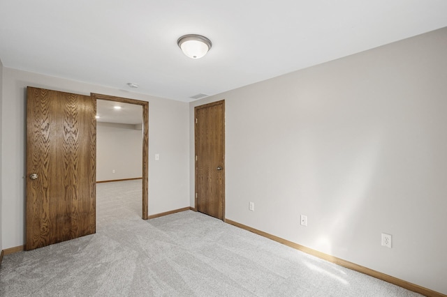 carpeted spare room with baseboards