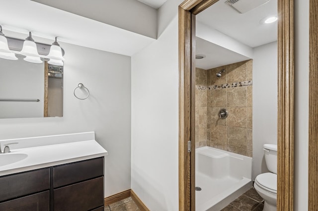 full bath with visible vents, toilet, a shower, baseboards, and vanity