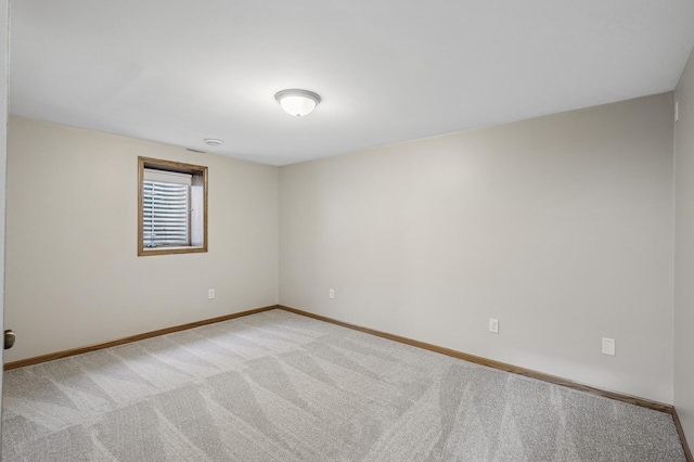 empty room with light carpet and baseboards