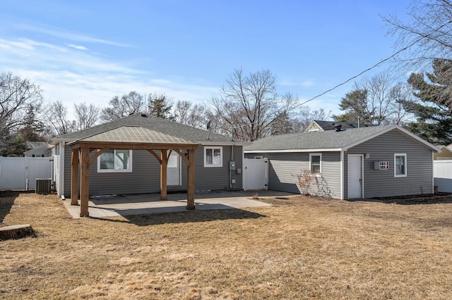 rear view of house featuring a gate, a patio, central AC, fence, and a gazebo