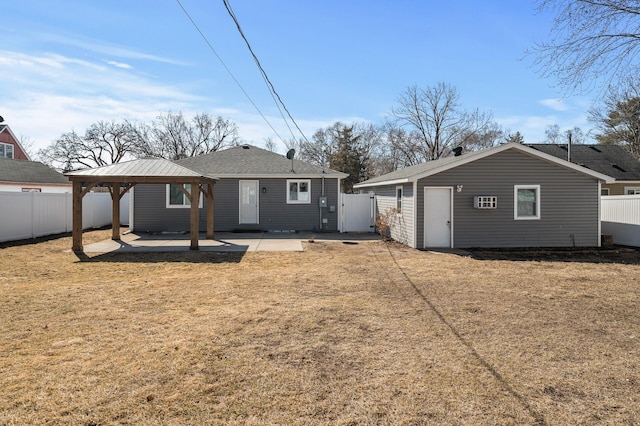 back of house with a gazebo, a patio, a lawn, and a fenced backyard