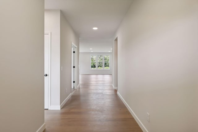 hallway with light hardwood / wood-style floors