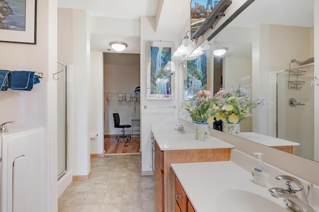 bathroom with an enclosed shower and vanity