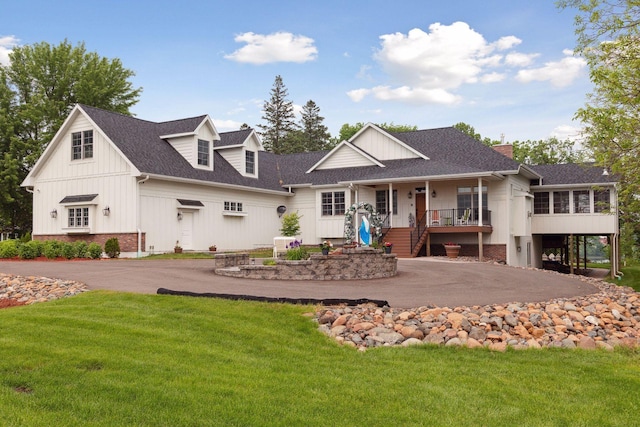 rear view of property featuring a yard