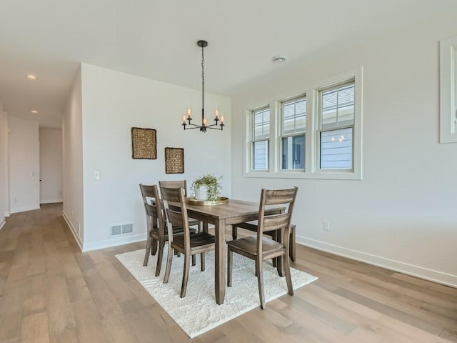 dining room featuring a chandelier and light hardwood / wood-style flooring