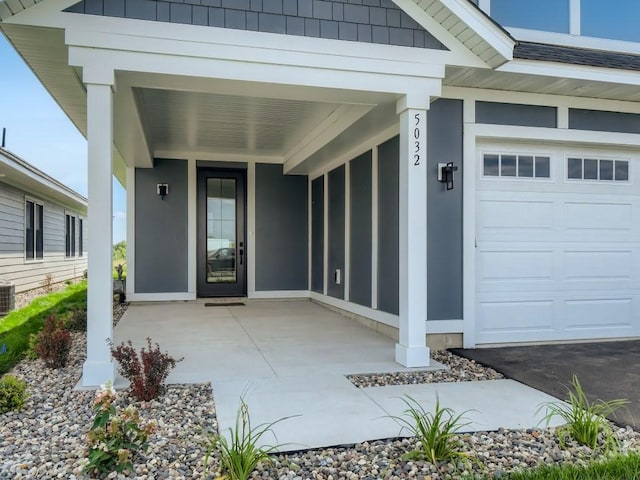 property entrance with a garage and central air condition unit