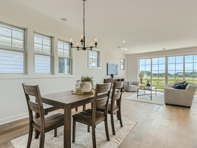 dining space featuring a chandelier and light hardwood / wood-style floors