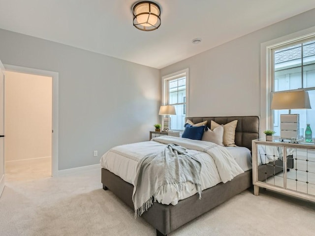 bedroom featuring light carpet