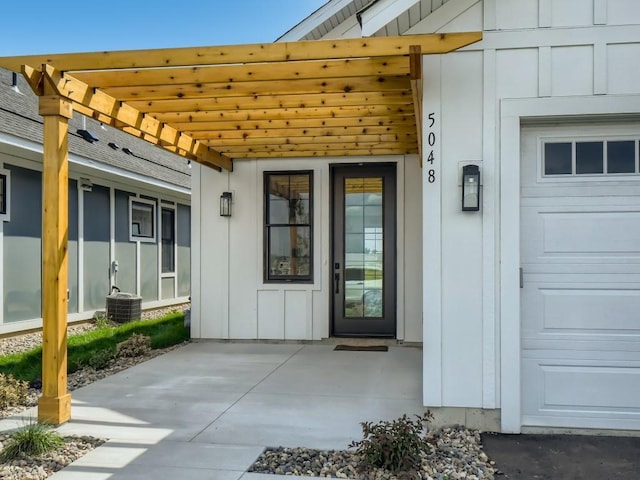 doorway to property featuring a pergola and central AC