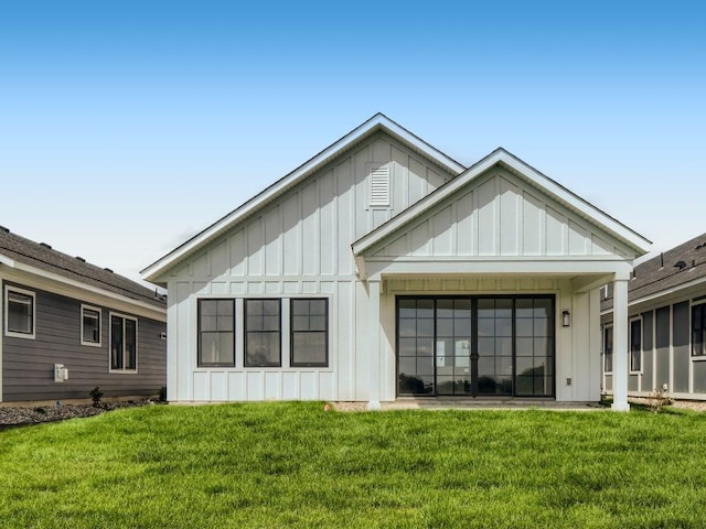 rear view of property with a yard