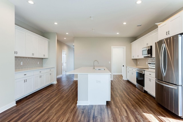 kitchen featuring sink, white cabinetry, a kitchen island with sink, and appliances with stainless steel finishes