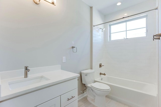 full bathroom with toilet, vanity, and tiled shower / bath