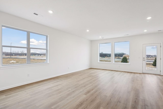 spare room featuring light hardwood / wood-style flooring