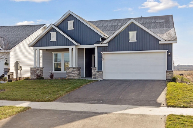 view of front of house with a front yard and a garage