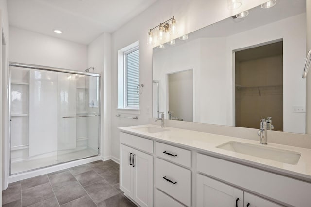 bathroom featuring an enclosed shower and vanity