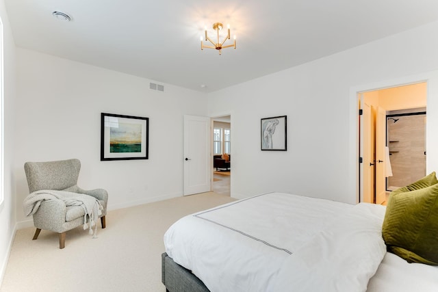 bedroom featuring ensuite bath, light carpet, and a chandelier