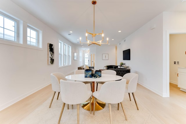 dining room featuring an inviting chandelier and light hardwood / wood-style flooring