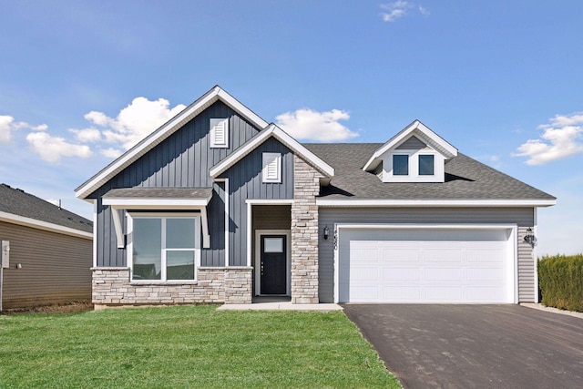 view of front facade with a front yard and a garage