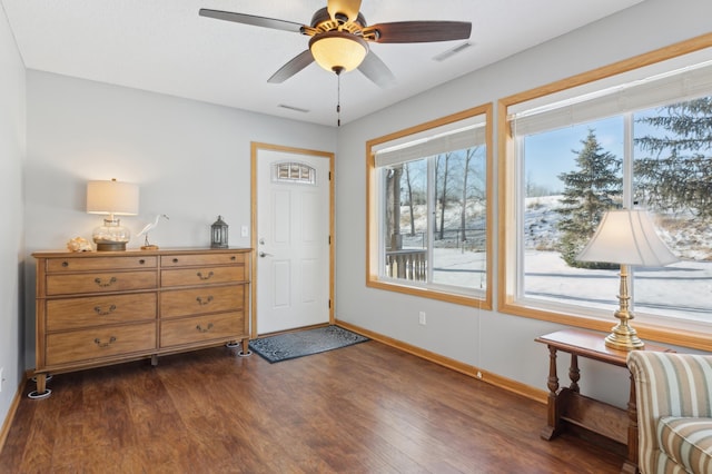 sitting room featuring ceiling fan and dark hardwood / wood-style flooring