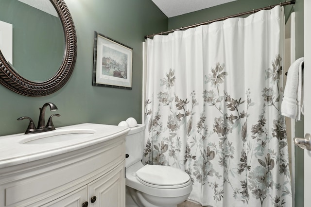 bathroom with toilet, vanity, a shower with shower curtain, and a textured ceiling