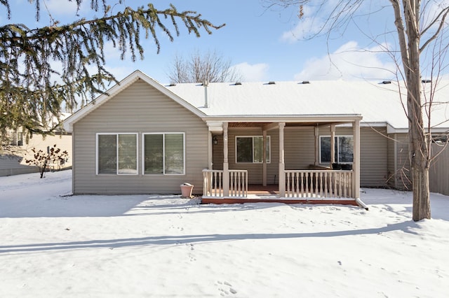 snow covered house with a porch