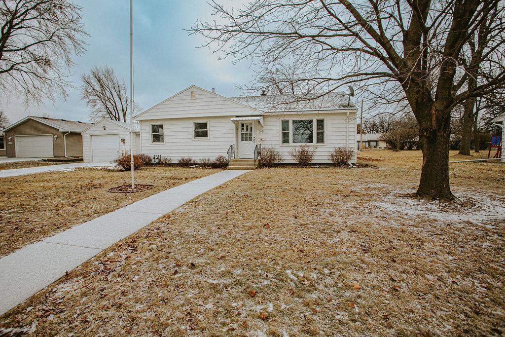 view of front of property featuring a garage and an outbuilding