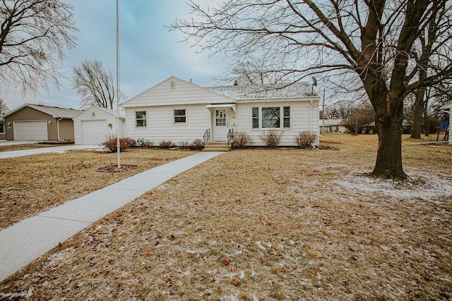 view of front of property featuring a garage and an outbuilding