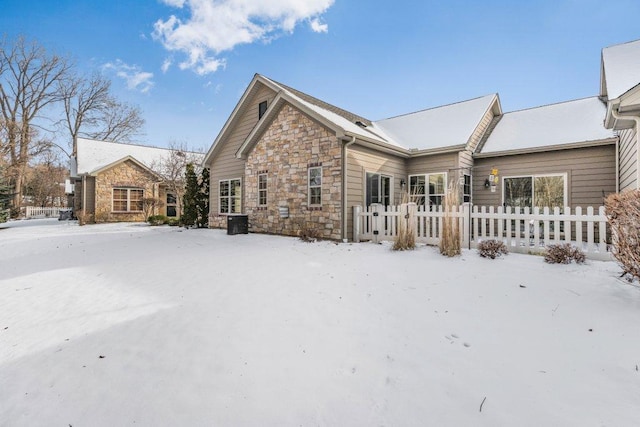 view of snow covered rear of property