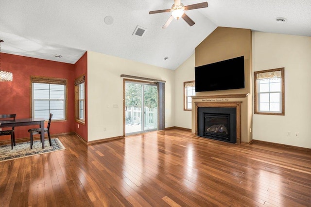 living room featuring hardwood / wood-style flooring, ceiling fan, and vaulted ceiling