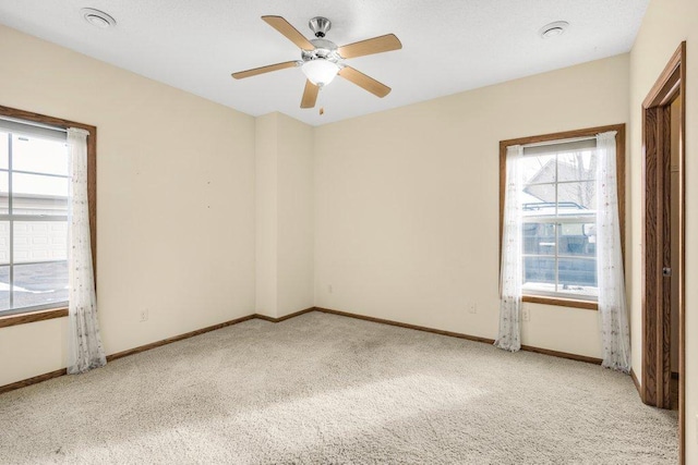 carpeted empty room with ceiling fan