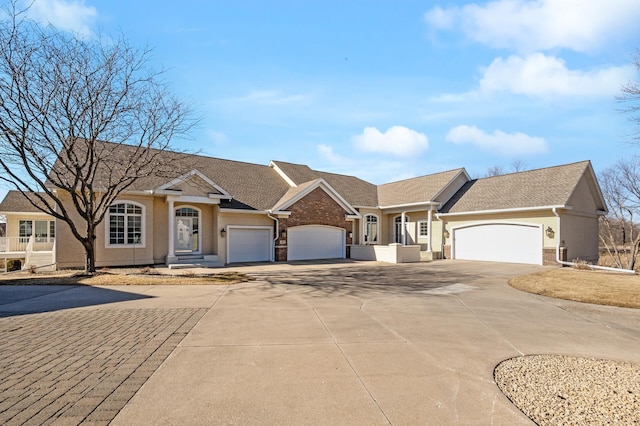 single story home featuring driveway, brick siding, an attached garage, and stucco siding