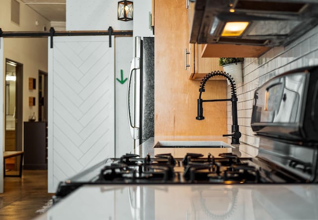 interior details with a barn door and fridge