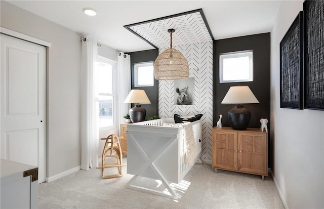 bedroom with an accent wall, carpet, and baseboards