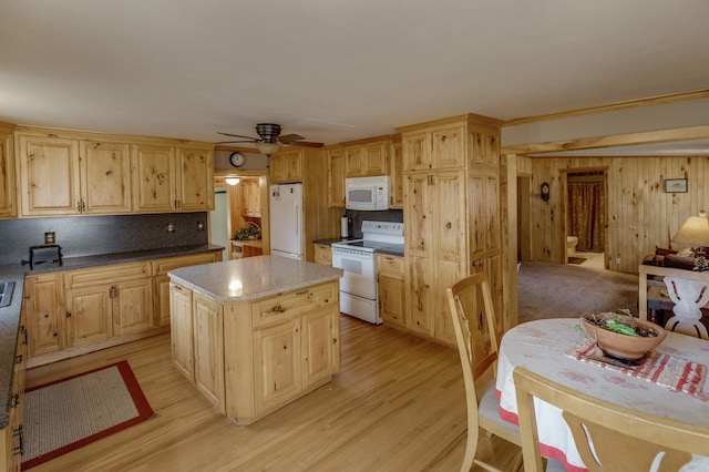 kitchen with ceiling fan, decorative backsplash, white appliances, light wood-type flooring, and a center island