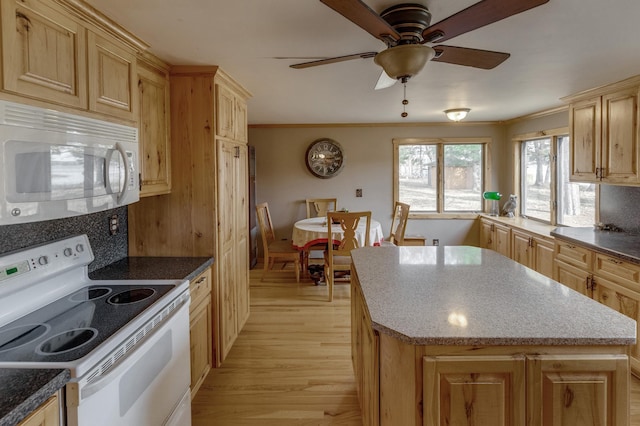 kitchen with light brown cabinetry, light wood-type flooring, white appliances, and ornamental molding