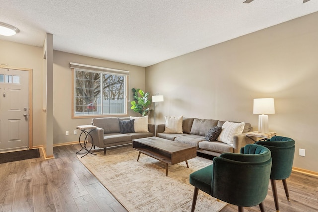 living room with wood-type flooring and a textured ceiling