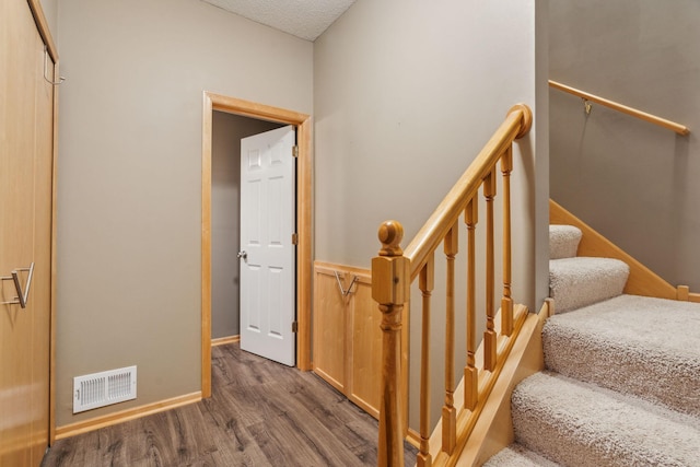 stairs with wood-type flooring