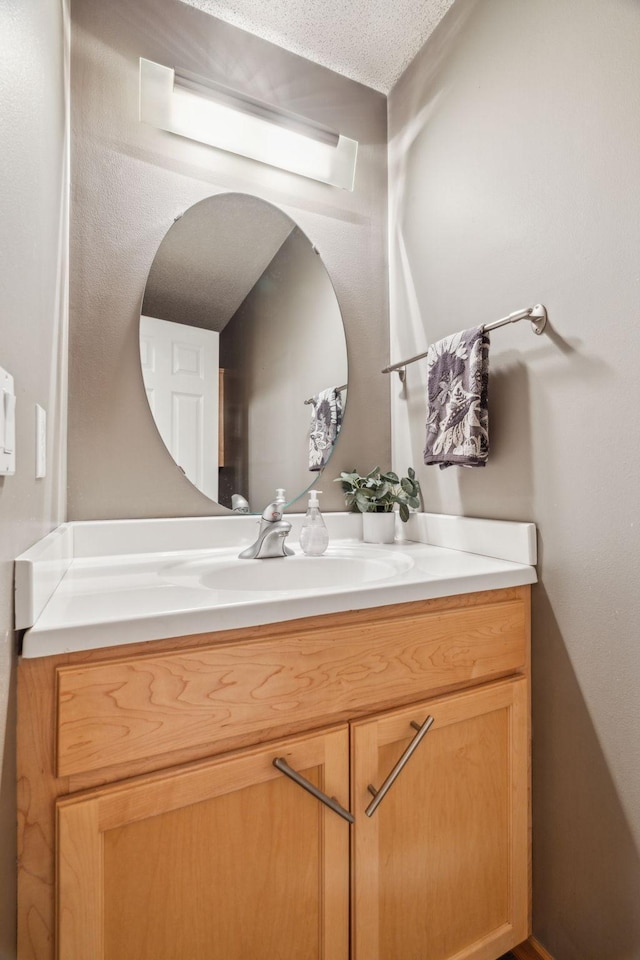 bathroom with vanity and a textured ceiling