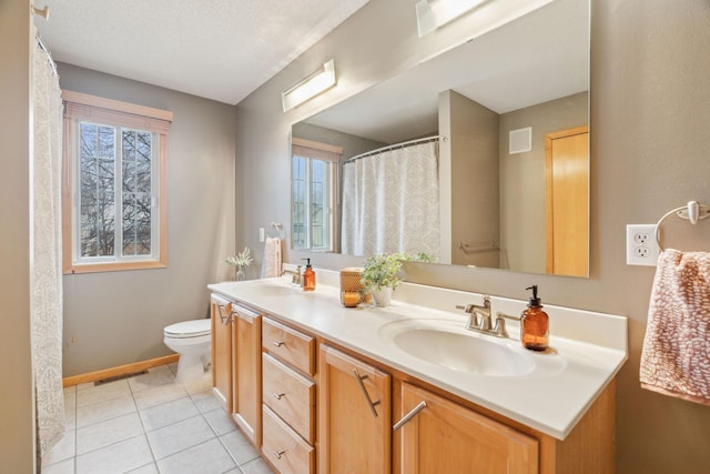 bathroom with toilet, a textured ceiling, tile patterned floors, and vanity