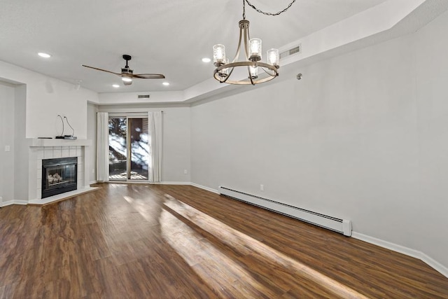 unfurnished living room featuring ceiling fan with notable chandelier, a baseboard radiator, a fireplace, and hardwood / wood-style floors