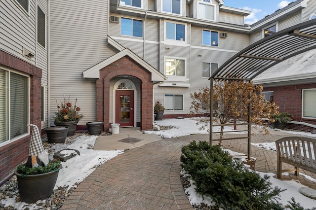 view of snow covered property entrance