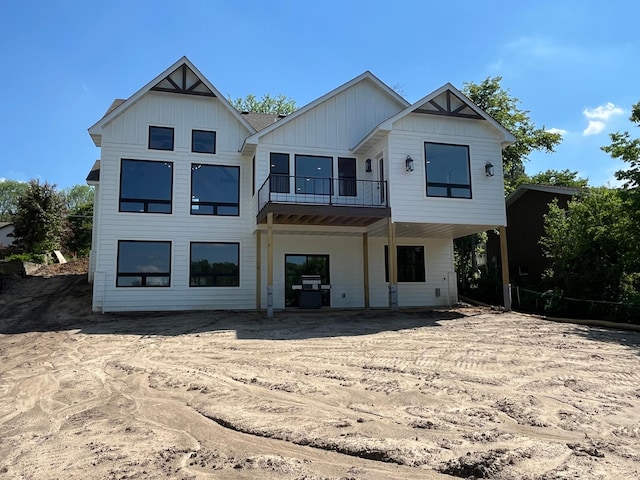 rear view of property with a balcony