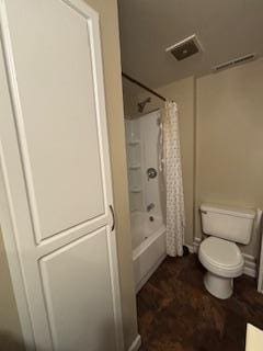 bathroom with toilet and shower / tub combo with curtain