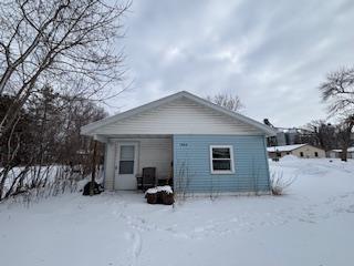 view of snow covered rear of property