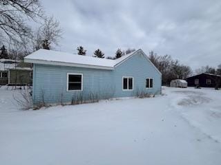 view of snow covered rear of property