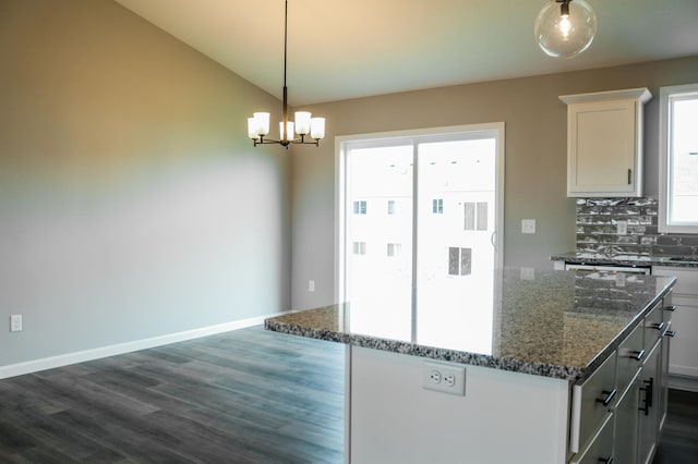 kitchen with plenty of natural light, backsplash, pendant lighting, and a center island