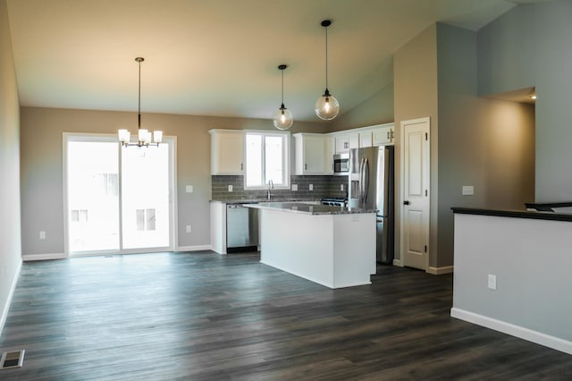 kitchen featuring white cabinetry, pendant lighting, a center island, and appliances with stainless steel finishes