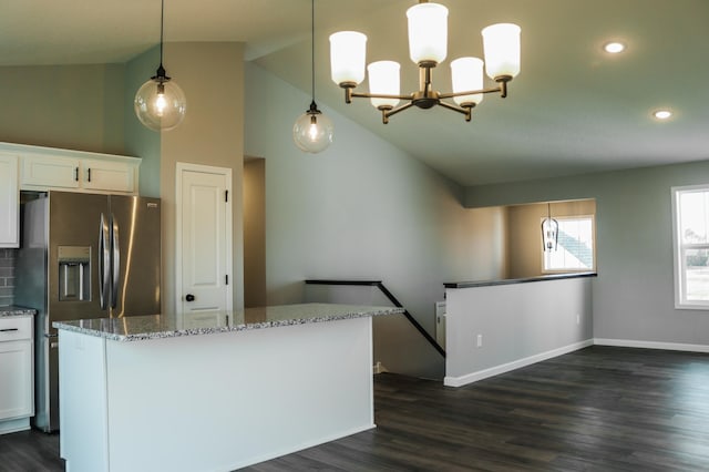 kitchen with white cabinetry, light stone counters, dark hardwood / wood-style floors, stainless steel fridge with ice dispenser, and hanging light fixtures